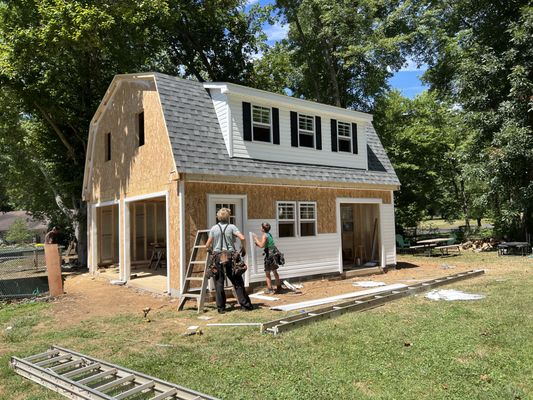 White Pine Structures crew building a two-story prefab garage on-site at a customer's property