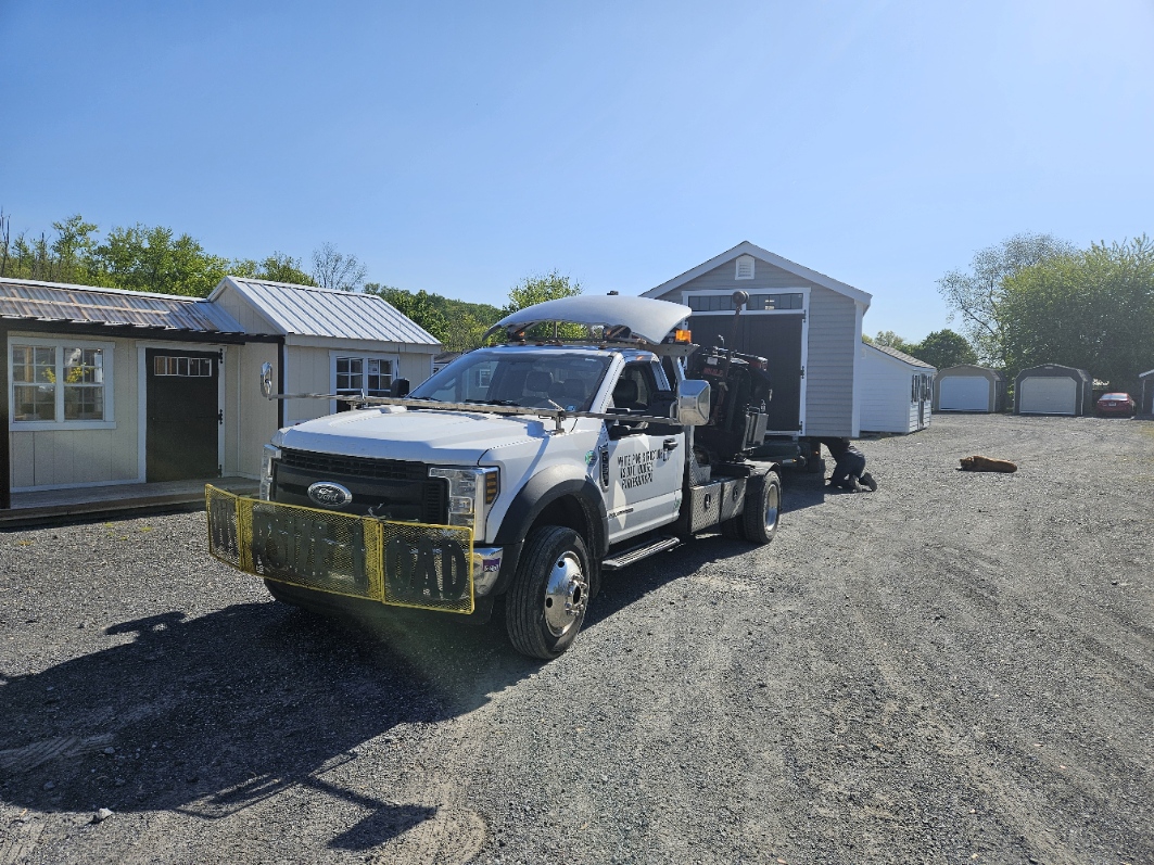 White Pine Structures mule truck — a heavy-duty Ford positioning a finished structure on the Parkesburg sales lot
